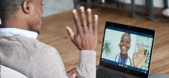 Photo of a male patient sitting down with laptop open waving at screen. Laptop screen display with health care provider on a virtual call waving to back to patient.